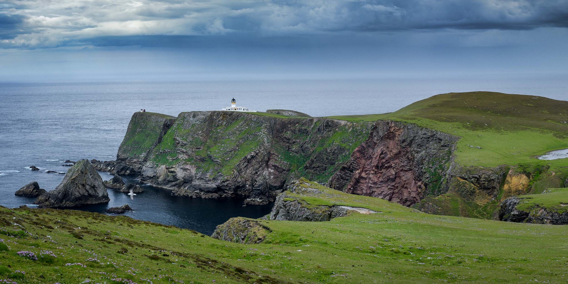 Cliffs, sea and a green landscape attract visitors to Fair Isle.