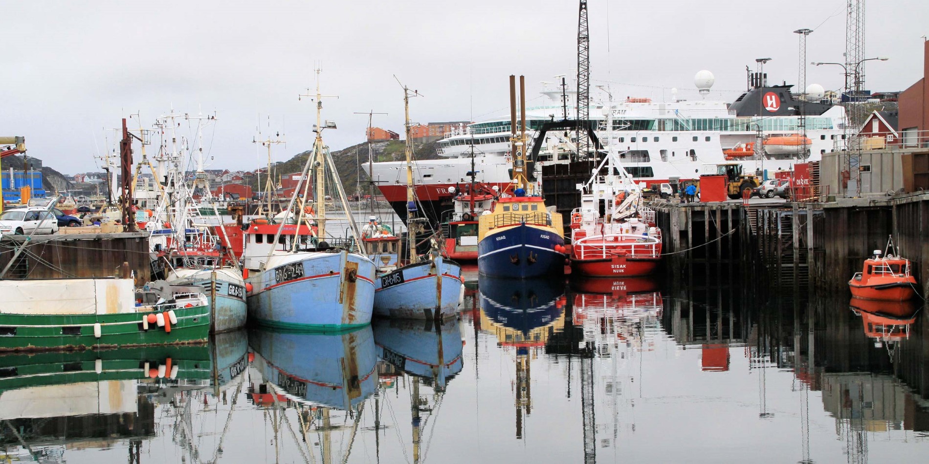 Hurtigruten in Nuuk harbour with fishing boats