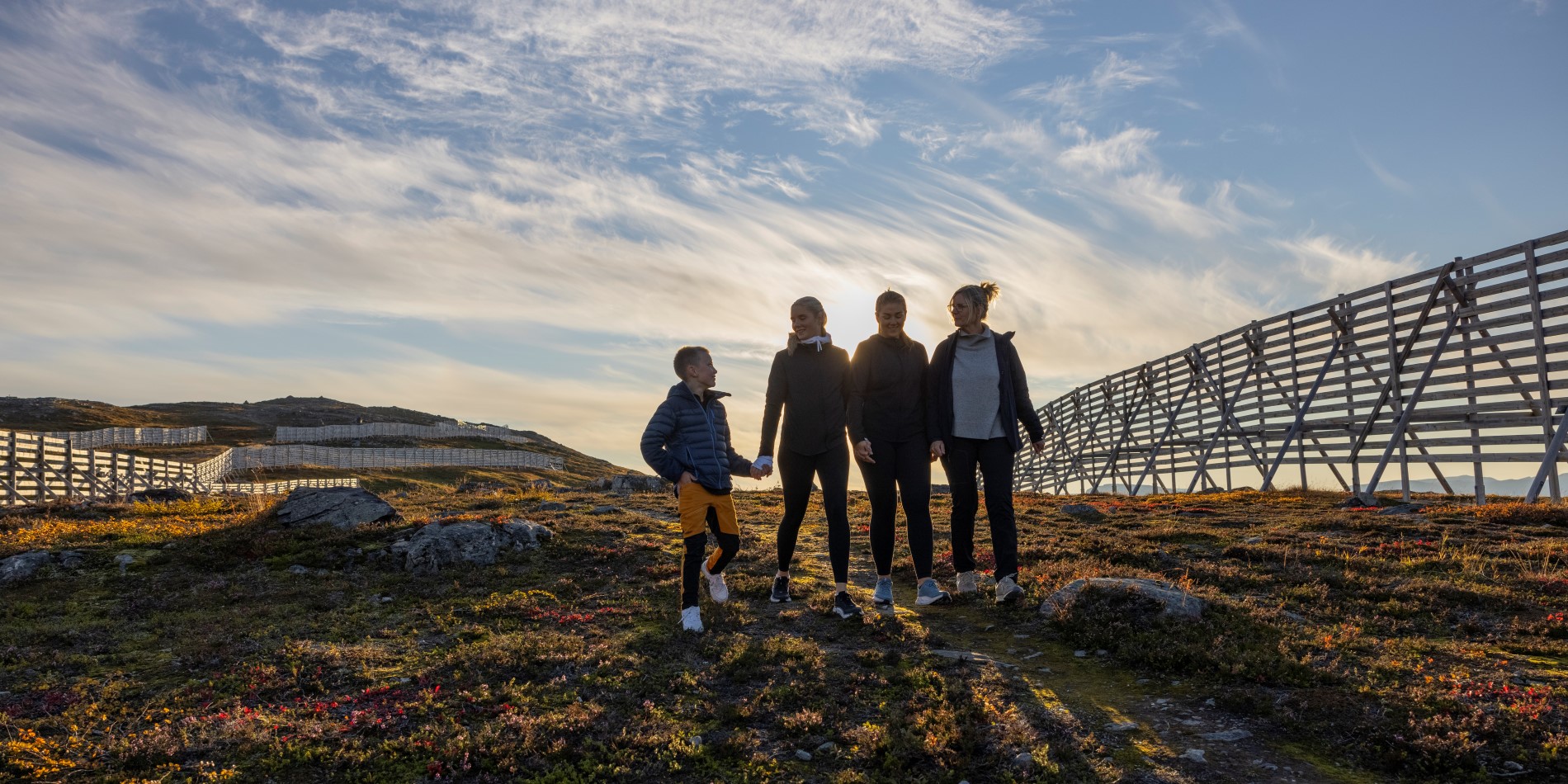 Three adults and a child on a hike in Hammerfest, Norway